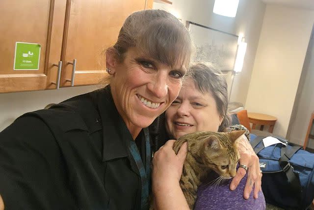 <p>Courtesy of Ginger Thompson</p> Ginger Thompson (right) and officer Tiffany Middleton, who reunited her with her Bengal cat Breezy after she was missing at the Denver International Airport for over 24 hours.