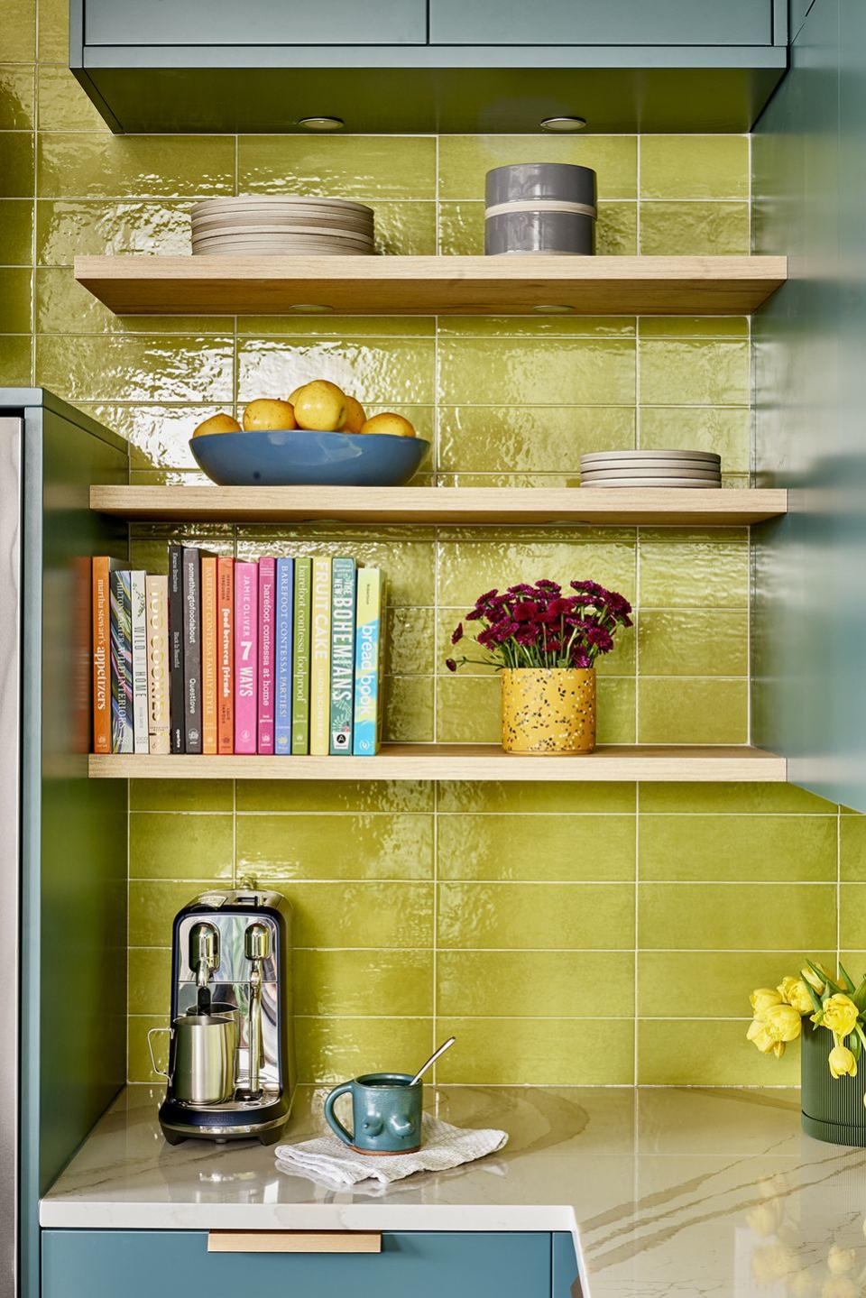 a kitchen with a shelf full of books and a tea pot