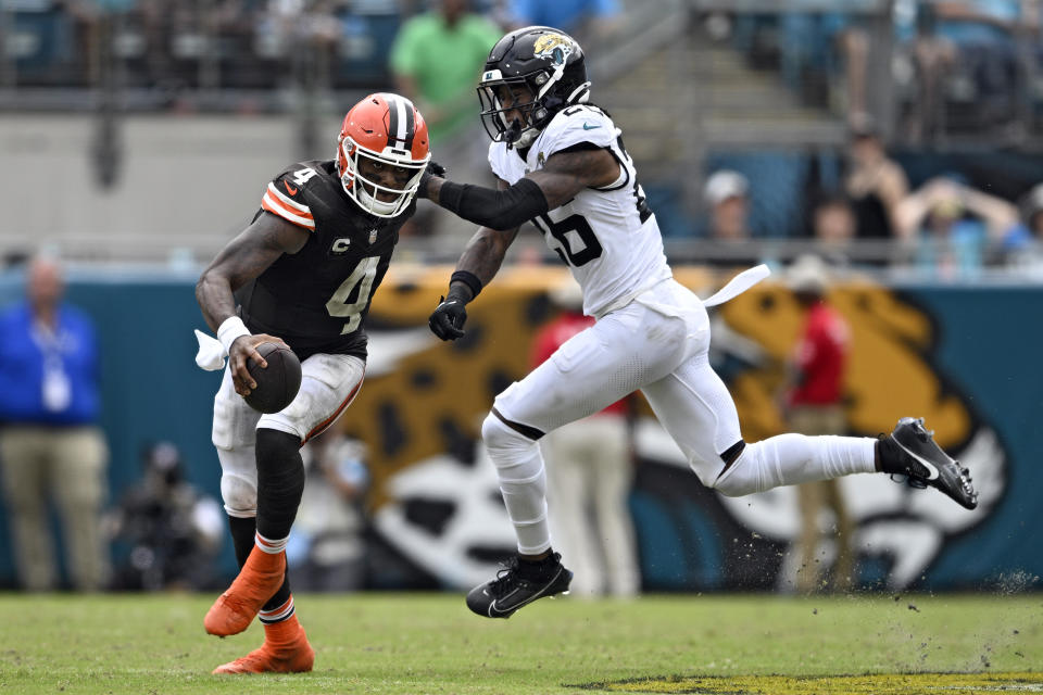 Cleveland Browns quarterback Deshaun Watson (4) scrambles away from Jacksonville Jaguars safety Antonio Johnson (26) during the second half of an NFL football game Sunday, Sept. 15, 2024, in Jacksonville, Fla. (AP Photo/Phelan M. Ebenhack)