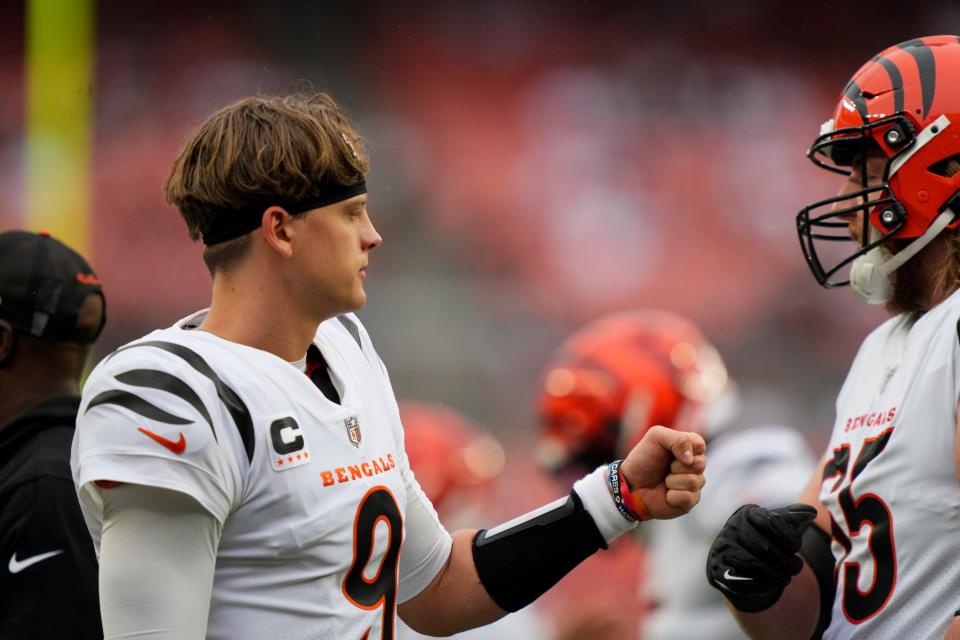 Cincinnati Bengals quarterback Joe Burrow (9) fist bumps teammates as the head to locker room before the first quarter of an NFL football game between the Cincinnati Bengals and Cleveland Browns, Sunday, Sept. 10, 2023, at Cleveland Browns Stadium in Cleveland.