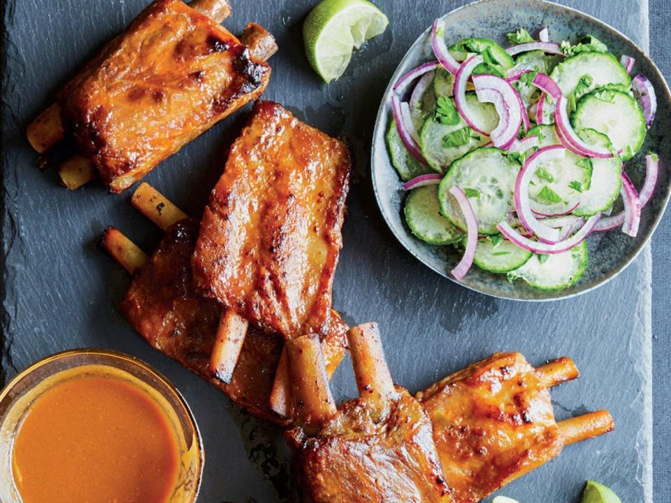 baby back ribs on a grey board with cucumber and red onion