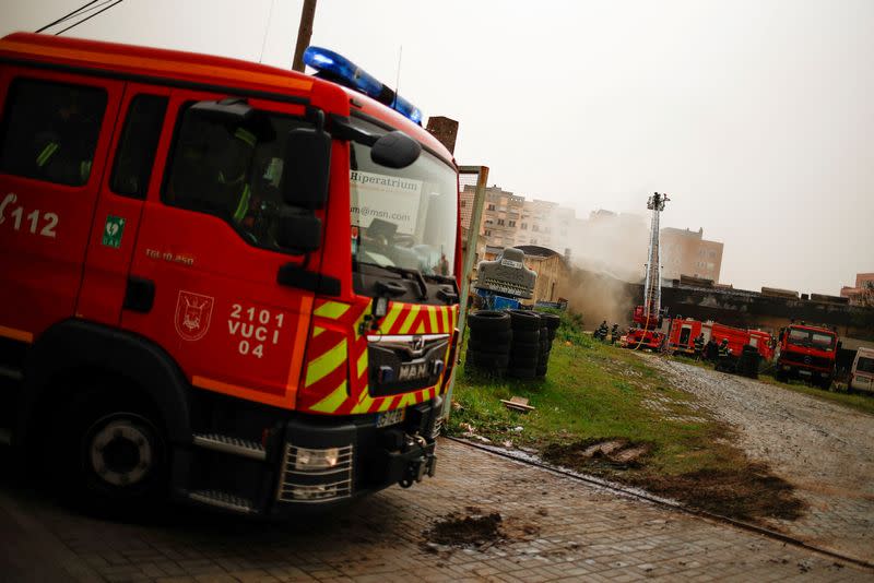 FILE PHOTO: Firefighters extinguish a fire in a tire warehouse in Lisbon