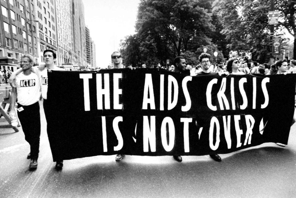 Gay ACT UP members carrying huge banner that reads THE AIDS CRISIS IS NOT OVER as they walk down the street during Gay & Lesbian Pride march.  (Photo by Michael Abramson/The LIFE Images Collection via Getty Images/Getty Images)