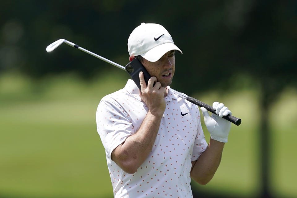 Rory McIlroy speaks on a cellular phone on the driving range during practice for the Tour Championship golf tournament at East Lake Golf Club Thursday, Sept. 3, 2020, in Atlanta. McIlroy is the last of 30 players to arrive at the Tour Championship and couldn't be more thrilled. His wife gave birth to their first child. McIlroy announced on social media that his daughter, Poppy Kennedy McIlroy, was born Monday in Florida. (AP Photo/John Bazemore)