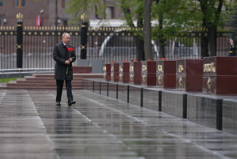 Russian President Vladimir Putin takes part in a flower-laying ceremony at the Tomb of the Unknown Soldier on Victory Day in central Moscow