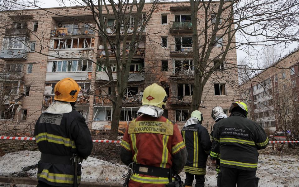 Firefighters gather near the apartment block