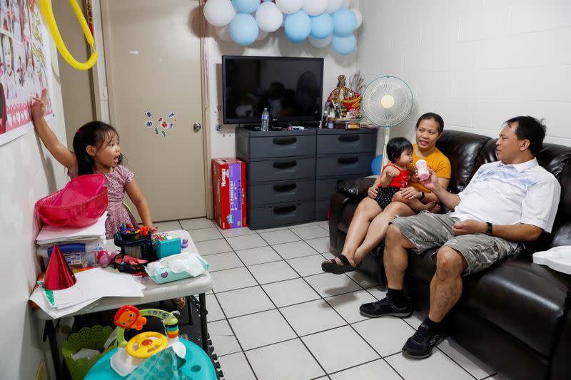 Judith and Jose Ramirez are pictured inside their home with their daughters, in Honolulu