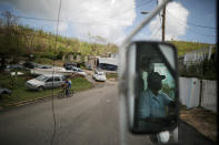 <p>Luis Menendez, a mail man for the U.S. Postal Service, delivers mail at an area affected by Hurricane Maria in the island of Vieques, Puerto Rico, Oct. 7, 2017. (Photo: Carlos Barria/Reuters) </p>