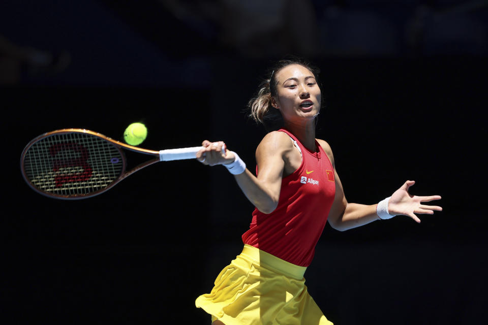 FILE - Zheng Qinwen, of China, hits a return to Iga Swiatek, of Poland, during the United Cup tennis tournament in Perth, Australia, Wednesday, Jan. 3, 2024. Zheng Qinwen is one of the players to watch at the Australian Open. The year's first Grand Slam tennis tournament is scheduled to start at Melbourne Park on Sunday, Jan. 14. (AP Photo/Trevor Collens, File)