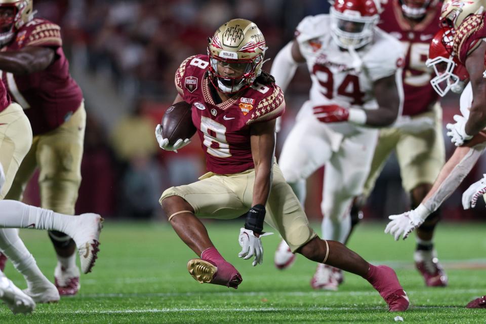 Dec 29, 2022; Orlando, Florida, USA; Florida State Seminoles running back Treshaun Ward (8) runs with the ball against the Oklahoma Sooners in the fourth quarter during the 2022 Cheez-It Bowl at Camping World Stadium. Mandatory Credit: Nathan Ray Seebeck-USA TODAY Sports