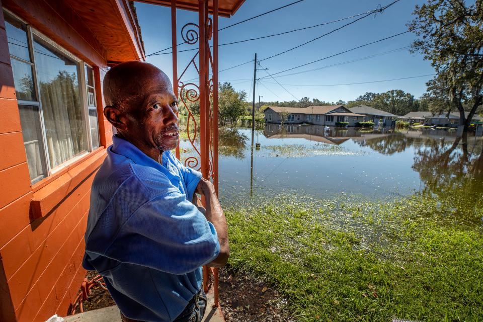 Richard Reid looks out onto his flooded yard on Booker Street In Bartow Fl. Monday October 3,2022Ernst Peters/.The Ledger
