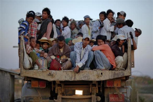 Workers are transported atop a truck after finishing work at a construction site in capital Naypyitaw, January 24, 2012.