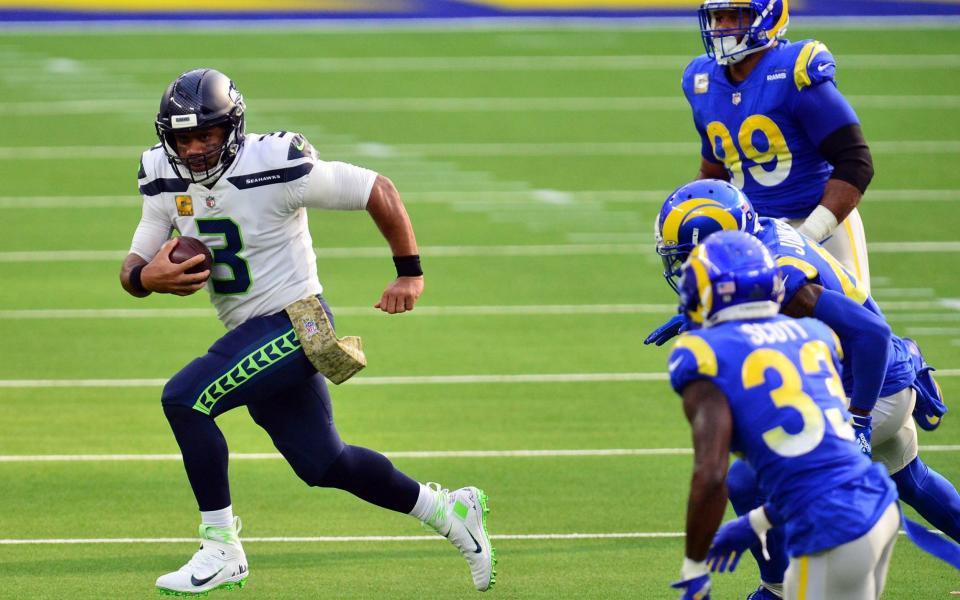 Seattle Seahawks quarterback Russell Wilson (3) runs the ball against the Los Angeles Rams defense during the first half at SoFi Stadium - Gary A. Vasquez-USA TODAY Sports