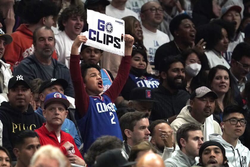 A young fan cheers for the Los Angeles Clippers during the second half of an NBA basketball play-in tournament game