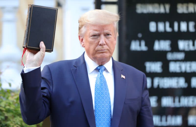 U.S. President Trump holds up Bible during photo opp in front of St John's Church in Washington, U.S.