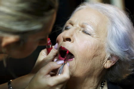 Holocaust survivor Hava Hershkovitz, 82, a previous beauty queen in the competition, has her make-up done during preparations ahead of a beauty contest for survivors of the Nazi genocide in the northern Israeli city of Haifa November 24, 2015. REUTERS/Amir Cohen
