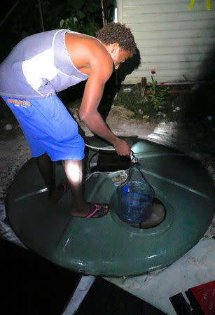 A detainee gets water from a makeshift well inside the Manus Island detention centre in Papua New Guinea, November 15, 2017. Picture taken November 15, 2017. ASRC/MartinWurt/Handout via REUTERS