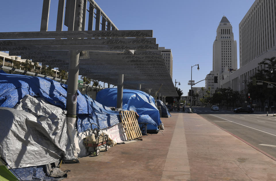 FILE - This May 21, 2020, file photo shows a homeless encampment atop the Main Street overpass of the 101 freeway during the coronavirus outbreak in downtown Los Angeles. The number of homeless people counted across Los Angeles County jumped 12.7% over the past year to more than 66,400, according to data released Friday, June 12, by the Los Angeles Homeless Services Authority. Authorities fear that figure will spike again once the full impact of the coronavirus pandemic is felt. (AP Photo/Mark J. Terrill, File)