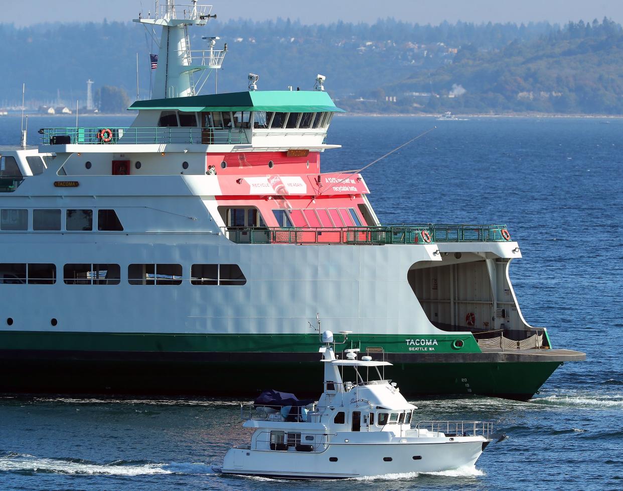 The Washington State Ferries vessel Tacoma, wrapped in red Coca-Cola advertising, enters Bainbridge Island’s Eagle Harbor on Oct. 5.