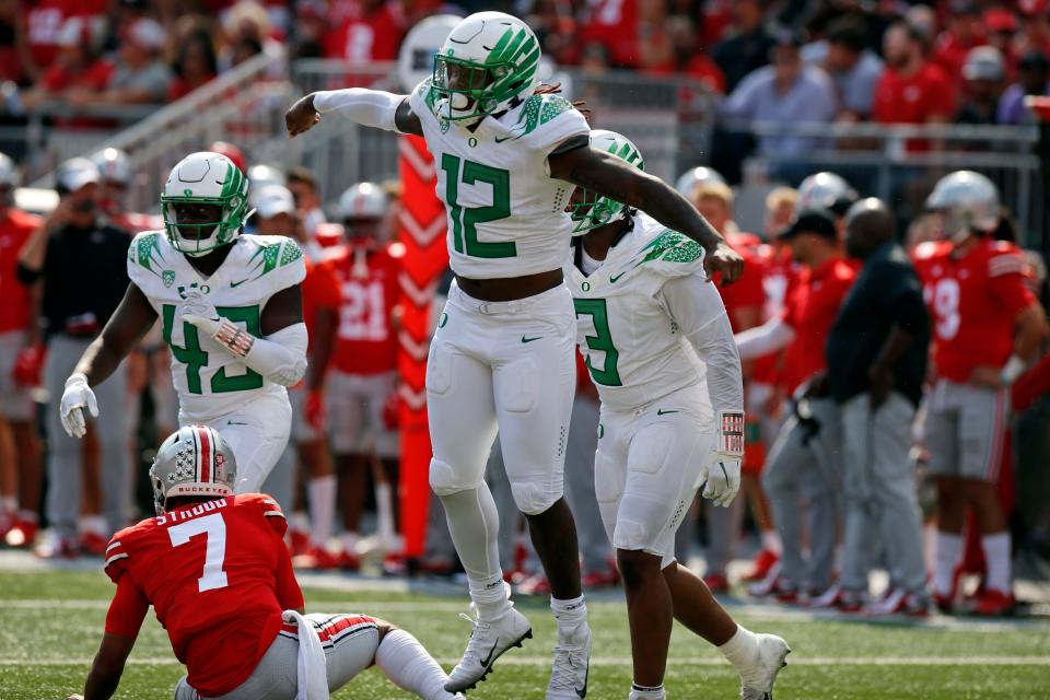 Oregon defensive end DJ Johnson, front, celebrates his sack of Ohio State quarterback C.J. Stroud on the final play of the game in the second half of an NCAA college football game Saturday, Sept. 11, 2021, in Columbus, Ohio. Oregon beat Ohio State 35-28.