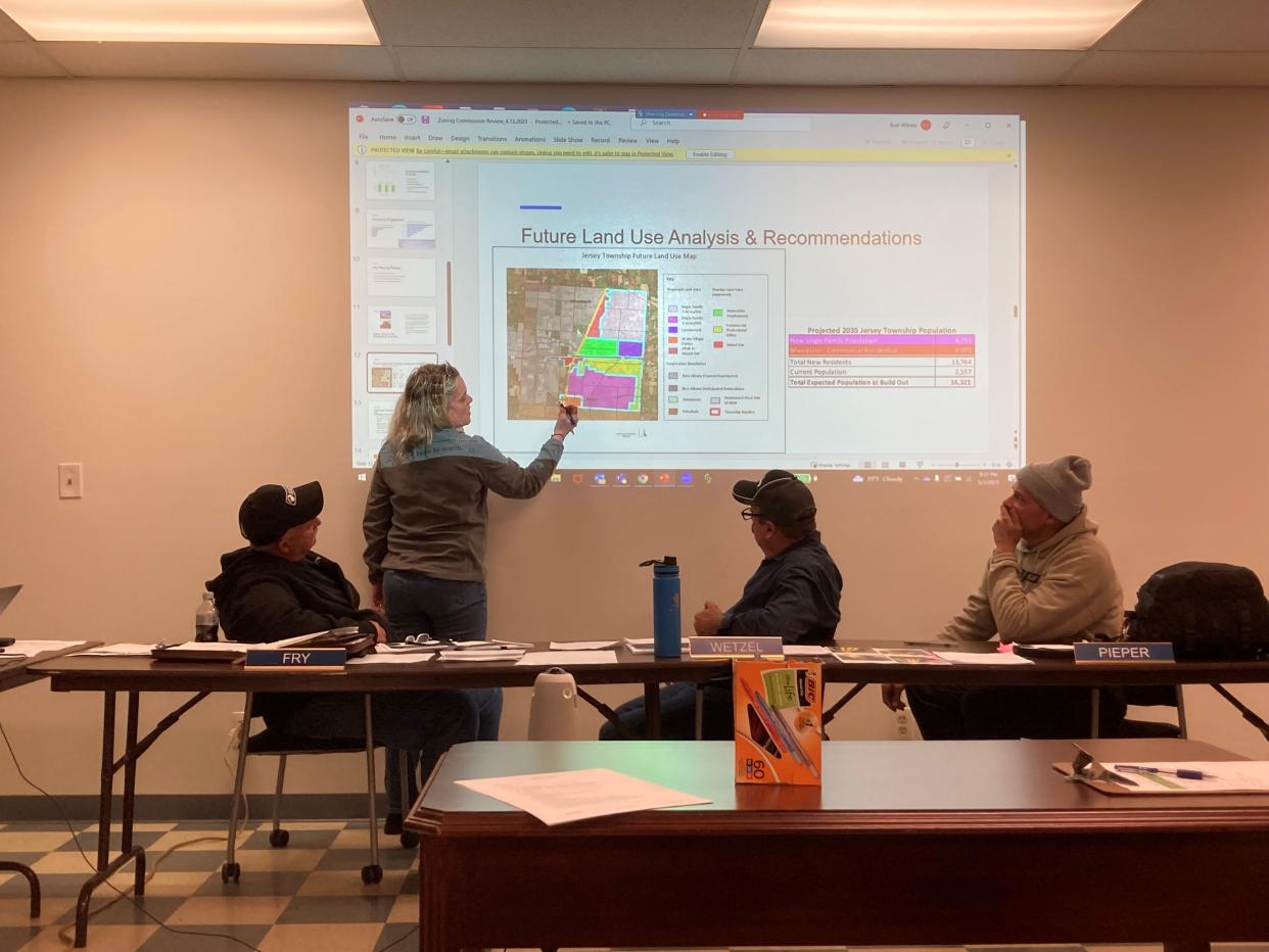 Holly Mattei, standing, explains the future land use map for Jersey Township to trustees, from left, Jeff Fry, Dan Wetzel and Ben Pieper during a township trustee meeting May 1. The map was included in the township's comprehensive plan that was approved during the meeting.