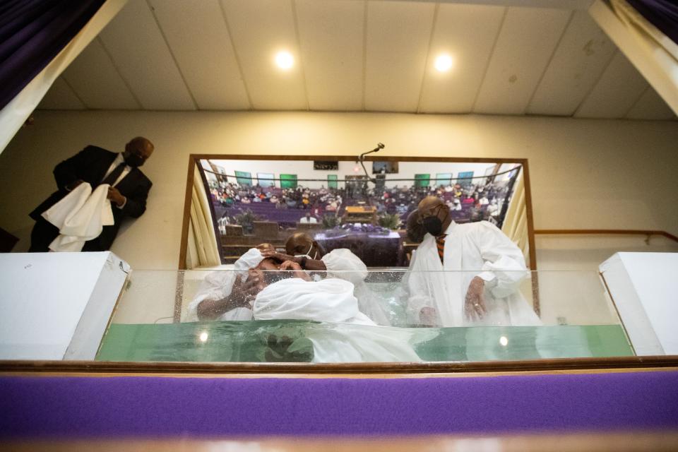 Rev. R.B. Holmes at Bethel Missionary Baptist Church baptizes nine Florida A&M University football players during service Sunday, Aug. 21, 2022.