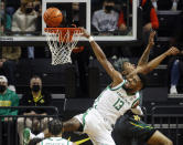 Oregon forward Quincy Guerrier (13), attempts a basket against Baylor in the first half during an NCAA college basketball game in Eugene, Ore., Saturday, Dec. 18, 2021. (AP Photo/Thomas Boyd)