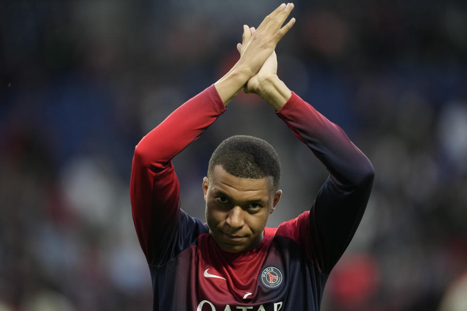 PSG's Kylian Mbappe greets supporters before the French League One soccer match between Paris Saint-Germain and Toulouse at the Parc des Princes stadium in Paris, Sunday, May 12, 2024. (AP Photo/Christophe Ena)