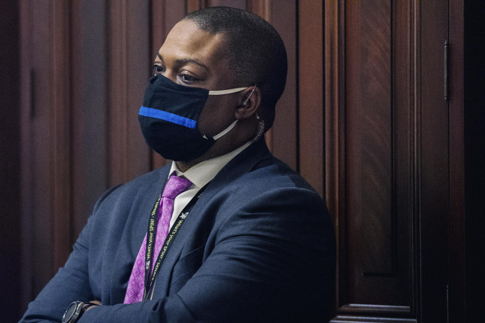 FILE - U.S. Capitol Police officer Eugene Goodman watches never-before-seen security footage of rioters storming the Capitol on Jan. 6, during the second day of former President Donald Trump's second impeachment trial, Wednesday, Feb. 10, 2021 in the Capitol in Washington. (Brandon Bell/The New York Times via AP, Pool)