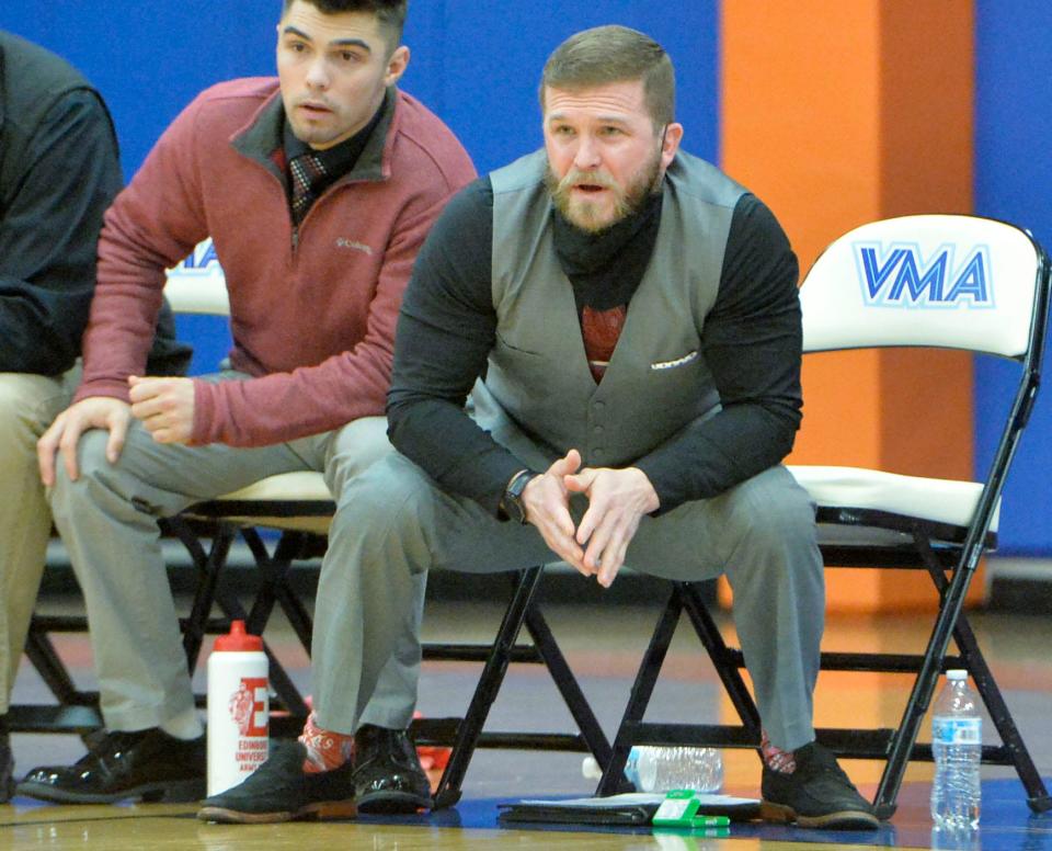 General McLane wrestling coach Ryan Cook (right) watches the Lancers compete during District 10's Class 3A team tournament this past Feb. 2 at the Hagerty Family Events Center's Joann Mullen Gymnasium. Cook also will coach the school's new girls wrestling program, which the General McLane School District approved on Aug. 12. McLane is the 56th state school, and the fourth in northwestern Pennsylvania, to add girls wrestling. The PIAA will sanction it as a sport if 100 schools do the same.