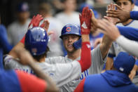 Chicago Cubs' Nico Hoerner celebrates in the dugout after scoring on a Andrelton Simmons groundout during the second inning of a baseball game against the Chicago White Sox at Guaranteed Rate Field, Saturday, May 28, 2022, in Chicago. (AP Photo/Paul Beaty)