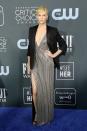 <p>Charlize Theron drapes a black blazer over her silver striped gown.</p>