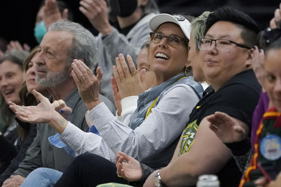 Seattle Storm co-owner Ginny Gilder, center, cheers as she sits courtside on May 18, 2022, at Climate Pledge Arena during a WNBA basketball game between the Seattle storm and the Chicago Sky in Seattle. As Title IX marks its 50th anniversary in 2022, Gilder is one of countless women who benefited from the enactment and execution of the law and translated those opportunities into becoming leaders in their professional careers. (AP Photo/Ted S. Warren)