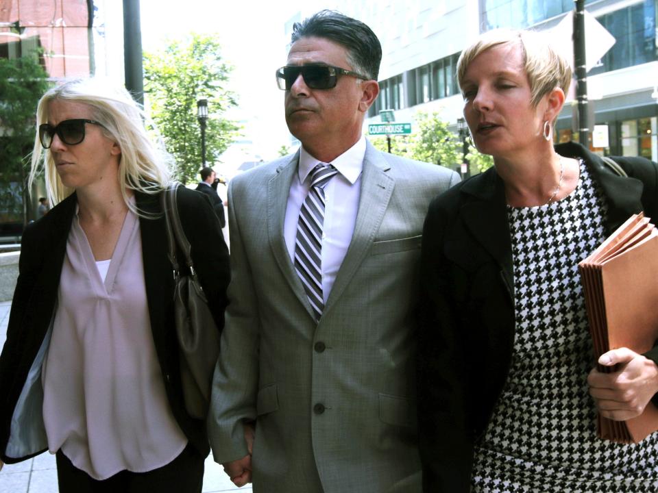 Former USC women's soccer coach Ali Khosroshahin, center, arrives at federal court, Thursday, June 27, 2019, to face charges in a nationwide college admissions bribery scandal, in Boston. Khosroshahin, who took bribes in exchange for helping unqualified kids get into USC, was sentenced Wednesday June 29, 2022, to six months in home confinement after cooperating with authorities investigating the sprawling college admissions scandal.