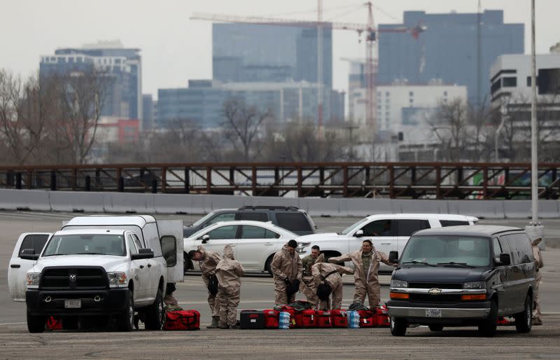 Members of the Colorado Air National Guard test people who suspect they are infected with coronavirus disease (COVID-19), at a drive-thru testing station, in Denver