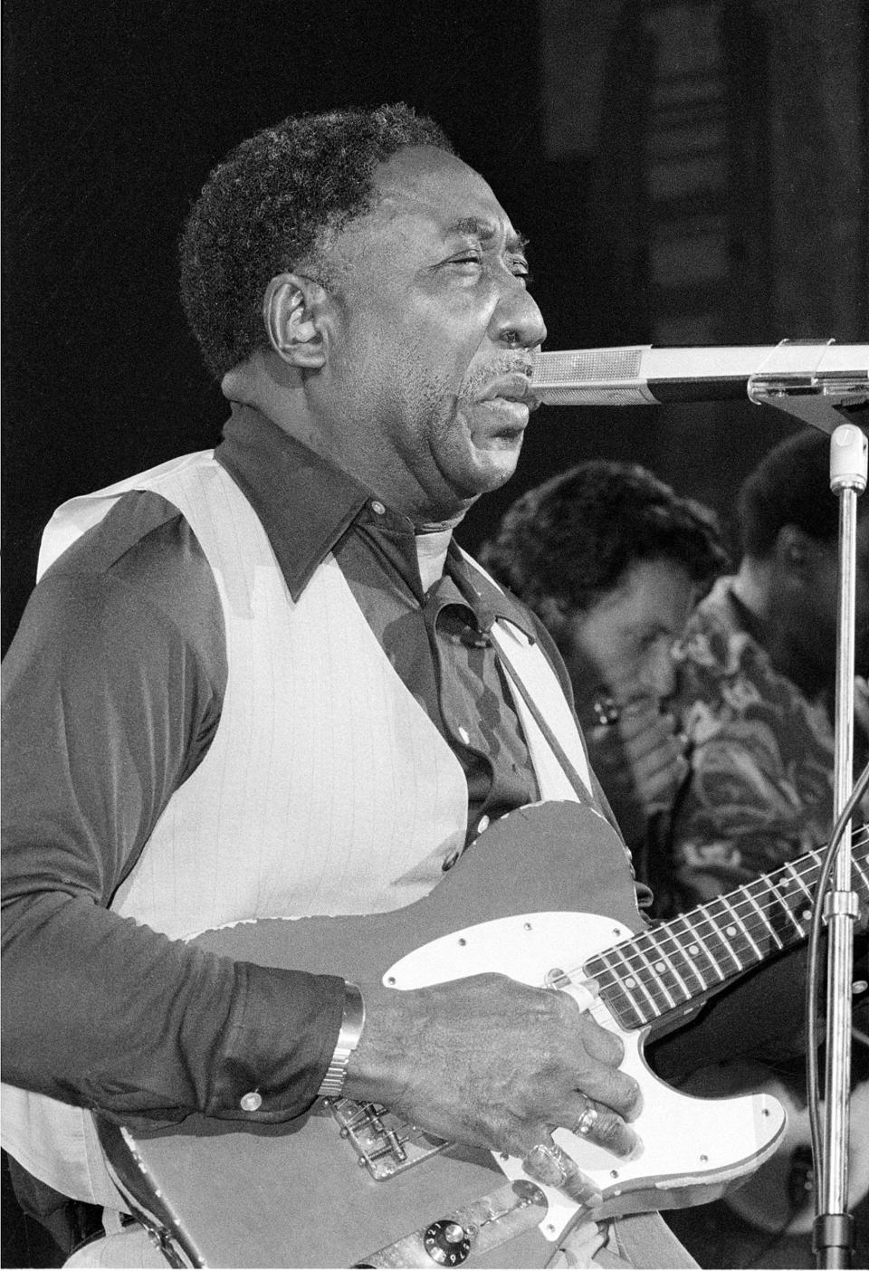 Blues musician Muddy Waters performs at New York's Palladium Theater, Oct. 1, 1977 in a benefit performance for the New York Public Library.  The proceeds will go to purchasing rare blues records.  (AP Photo)