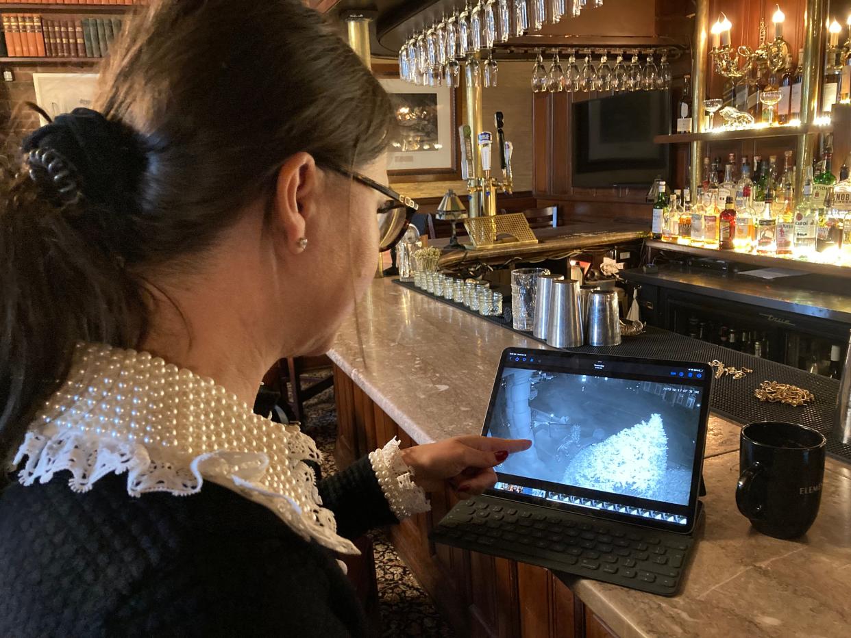 Restaurant co-owner Adrienne Waterman points to the moment in a video showing an unknown presence moving past a secuity camera outside the Portsmouth restaurant Wednesday, Oct. 18, 2023.