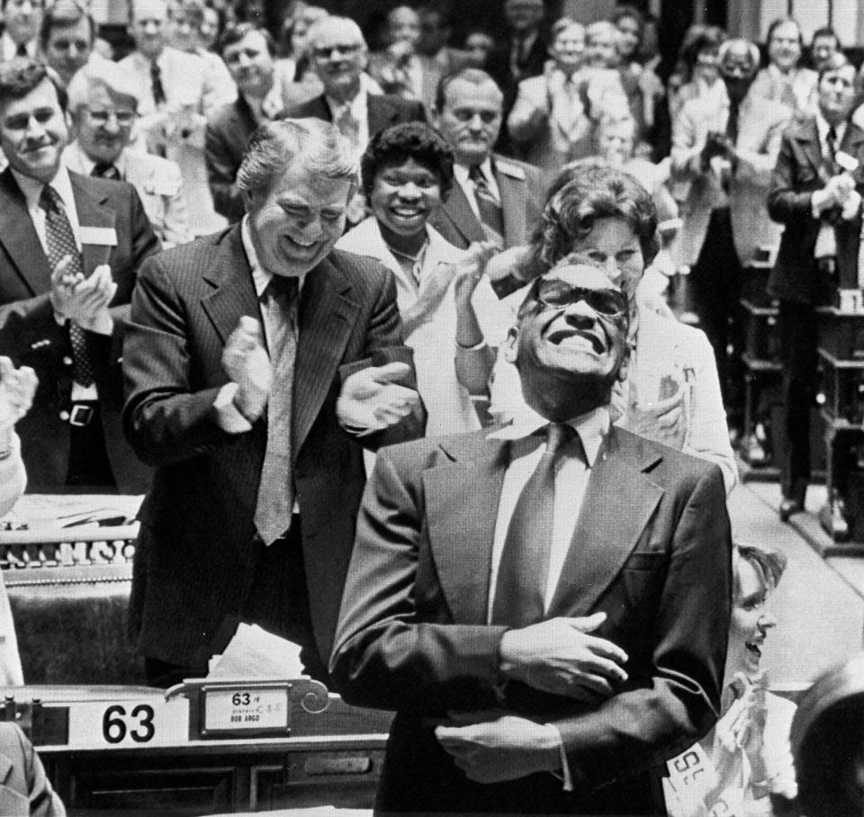 Georgia native son, singer Ray Charles, rocks to the ovation he received from a joint session of the Georgia Legislature in Atlanta, March 7, 1979. The Assembly made his version of the song "Georgia On My Mind" the official state song after he sang it to the session. (AP Photo/Charles Kelly)