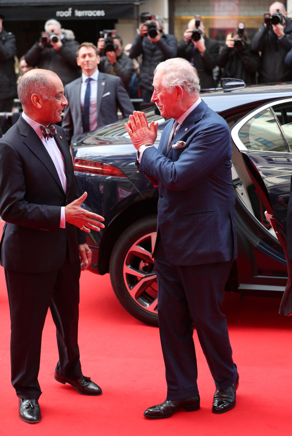 The Prince of Wales goes to shake the hand of Sir Kenneth Olisa, The Lord-Lieutenant of Greater London (left) before he changes to use a Namaste gesture, as he arrives at the annual Prince's Trust Awards 2020 held at the London Palladium.