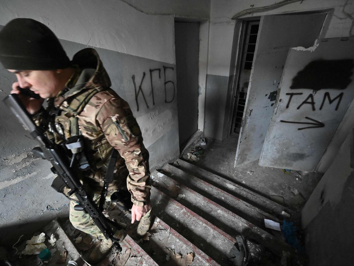 A Ukrainian policeman walks in a basement of the regional police headquarters, allegedly used as a torture site of pro-Ukrainian citizens (GENYA SAVILOV/AFP via Getty Images)