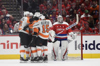 Philadelphia Flyers defenseman Matt Niskanen (15) and others celebrate a goal by center Kevin Hayes, obscured, as Washington Capitals goaltender Braden Holtby (70) watches during the second period of an NHL hockey game Wednesday, March 4, 2020, in Washington. The Flyers won 5-2. (AP Photo/Nick Wass)