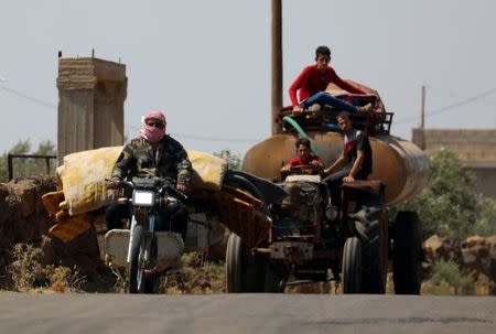 A man rides a motorbike with belongings in Deraa countryside, Syria June 22, 2018. REUTERS/Alaa al-Faqir