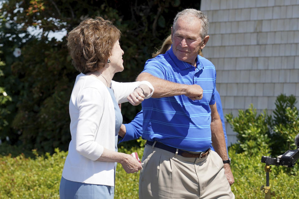 Former President George W. Bush gives an elbow bump to Sen. Susan Collins, R-Maine, Friday, Aug. 21, 2020, in Kennebunkport, Maine. (AP Photo/Mary Schwalm)