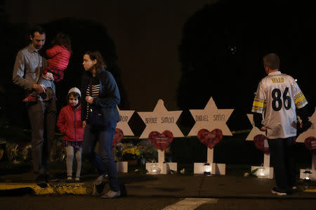 Mourners visit a makeshift memorial outside the Tree of Life synagogue, a day after 11 Jewish worshippers were shot dead in Pittsburgh, Pennsylvania, U.S., October 28, 2018. REUTERS/Cathal McNaughton