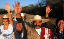 <p>People celebrate as the sun rises on the spring equinox at the Seven Dolls Temple, in the Mayan ruins of Dzibilchaltun, in the Mexican state of Yucatan.</p>