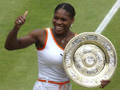 FILE - Serena Williams gives the thumbs up as she holds her trophy after defeating her sister Venus in the women's singles final on the Centre Court at the All England Lawn Tennis Championships at Wimbledon, Saturday July 5, 2003. Saying “the countdown has begun,” 23-time Grand Slam champion Serena Williams announced Tuesday, Aug. 9, 2022, she is ready to step away from tennis so she can turn her focus to having another child and her business interests, presaging the end of a career that transcended sports. (AP Photo/Jytte Nielsen, File)