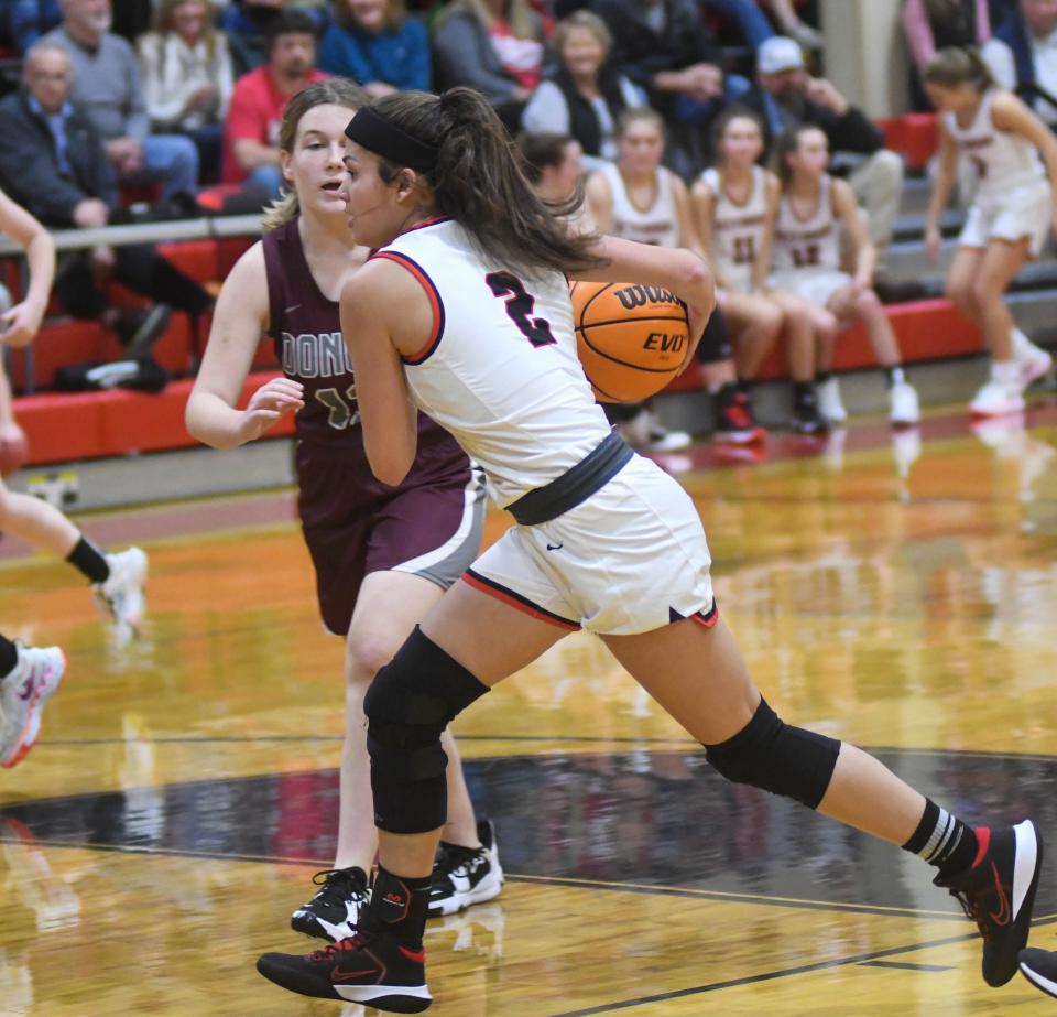 Westbrook Christian's Bella Millirons (right) drives to the hoop against Donoho in a  girls basketball game against on Friday, Dec. 10, 2021 in Rainbow City, Alabama.