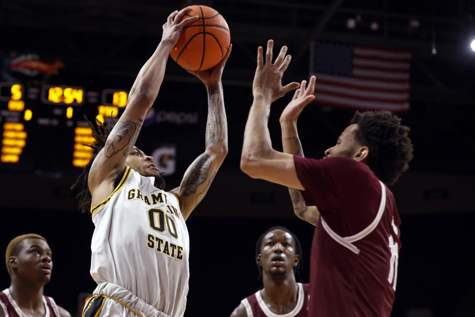 Grambling State guard Virshon Cotton (00) shoots over Texas Southern guard Jordan Gilliam (11) during the first half of an NCAA college basketball game in the championship of the Southwestern Athletic Conference Tournament, Saturday, March 11, 2023, in Birmingham, Ala. (AP Photo/Butch Dill)