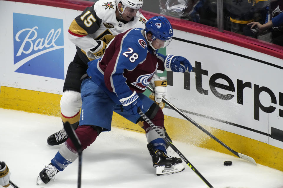 Colorado Avalanche defenseman Ryan Murray, front, fights for control of the puck with Vegas Golden Knights center Jake Leschyshyn in the third period of an NHL hockey game Tuesday, Oct. 26, 2021, in Denver. The Golden Knights won 3-1. (AP Photo/David Zalubowski)