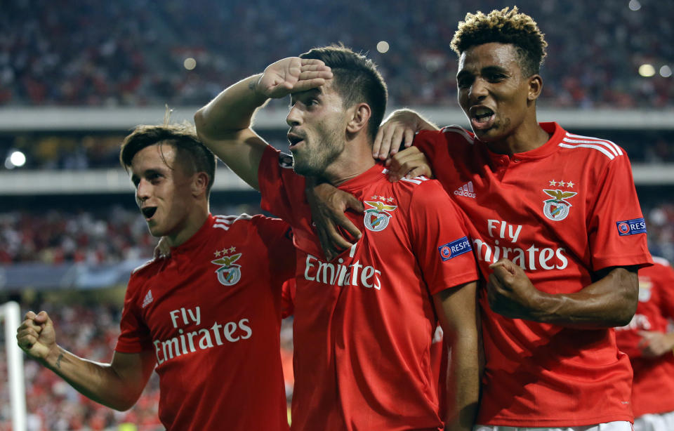 Benfica's Pizzi, center, celebrates scoring his side's first goal from a penalty kick during the Champions League playoffs, first leg, soccer match between Benfica and PAOK at the Luz stadium in Lisbon, Tuesday, Aug. 21, 2018. (AP Photo/Armando Franca)